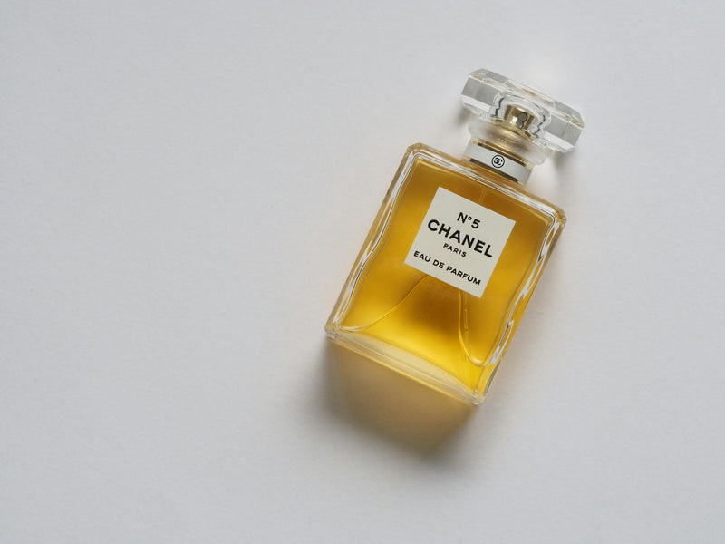 Minimal luxury fragrance bottles styled in a modern perfume house setting